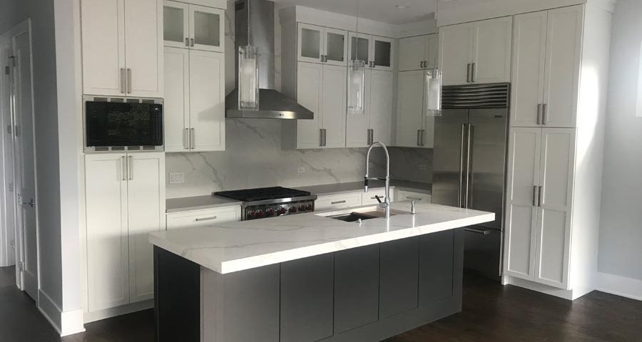 white kitchen with microwave, fridge, and stove trim